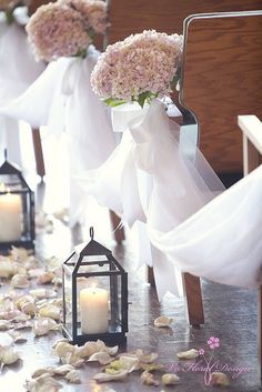 flowers and candles are lined up along the pews