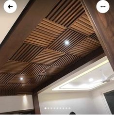 the ceiling is made out of wood and has two different lighting spots on each side