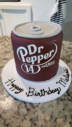 a birthday cake made to look like a dr pepper can on top of a counter