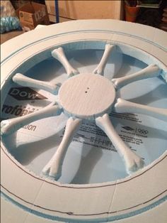 a close up of a white fan on a table