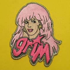 an embroidered patch with the word girl in pink and stars on it's face