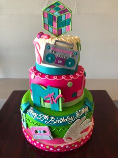 a multi - tiered birthday cake decorated with cars and blocks