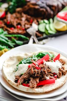 a close up of a plate of food with meat and veggies on it