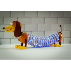 a toy dachshund is sitting on the table with its light up legs