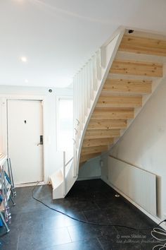 an empty room with stairs and tools on the floor