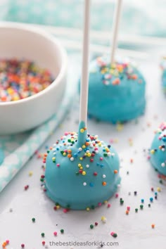 blue cake pops with sprinkles on them