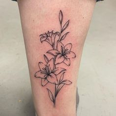 a black and white flower tattoo on the leg