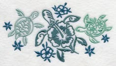 three turtles and flowers on a white towel with blue trimmings in the middle