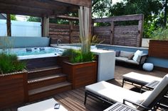 a hot tub sitting on top of a wooden deck