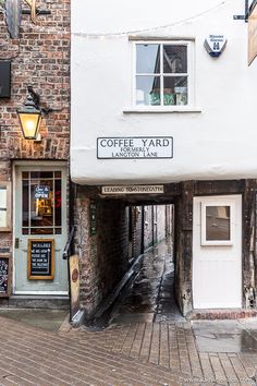 the entrance to coffee yard on an old brick building in dublin, ireland with cobblestone streets