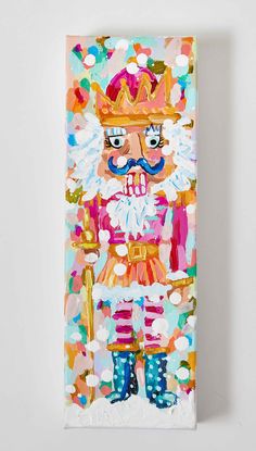 a painting of a nutcracker wearing a crown and holding a cane in front of a white wall