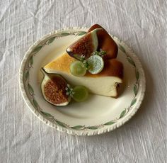 a white plate topped with slices of cheese covered in fruit