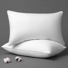 a pillow and some cotton on a gray background