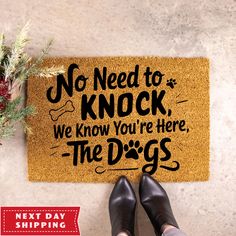 a door mat that says no need to knock, we know you're here the dogs