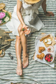 a woman sitting on top of a bed with food