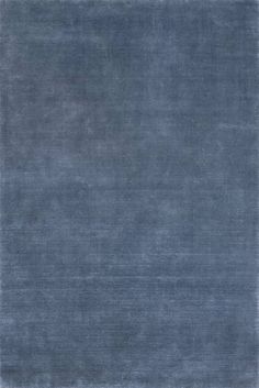 an area rug that has been made in blue and grey tones with a white border