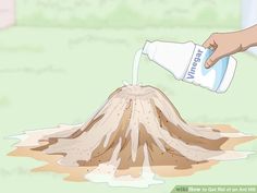 a person pouring water into a mound of dirt that has been turned into a volcano