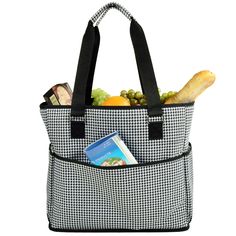 a black and white tote bag filled with fruit, bread, and other items