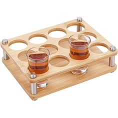 three shot glasses on a wooden tray