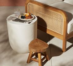 a table with food and drinks on it next to a white couch in a room