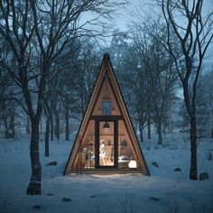 a - frame cabin in the woods is lit up at night