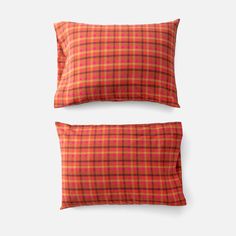 two orange and red plaid pillow cases