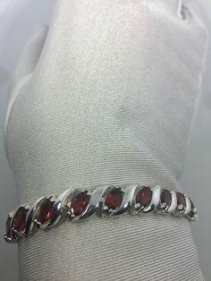 Vintage Red Garnet Bracelet Sterling Silver Deco Tennis This genuine bright red Garnets bracelet is very lively and bright. The stones are deep colors and well matched. The sterling silver is plated with rhodium to protect the bracelet from tarnish This is 7.5 in My jeweler can re size this for a $20 fee. All jewelry is shipped free in the US in a nice gift box. Check out our over a THOUSAND great reviews Engraving is $4 per letter and is not always perfect depending on the piece. It can take a Elegant Red Round Bracelets, Luxury Red Sterling Silver Bracelets, Elegant Red Jubilee Bracelet, Luxury Red Oval Bracelet, Luxury Red Tennis Bracelet As Gift, Red Round Tennis Bracelet For Formal Occasions, Elegant Red Ruby Bracelets, Red Oval Fine Jewelry Tennis Bracelet, Red Oval Tennis Bracelet Fine Jewelry