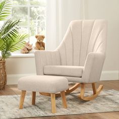 a rocking chair and footstool with a teddy bear on the floor next to it