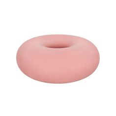 a pink donut pillow sitting on top of a white surface