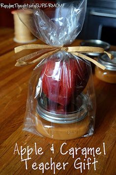 an apple and caramel teacher gift in a jar on a wooden table with text overlay