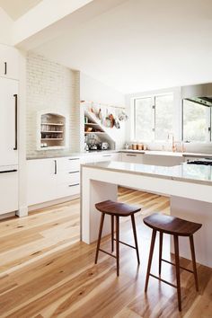 two stools sit in front of the kitchen island