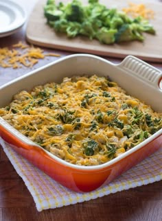 a casserole dish with broccoli and cheese in it on a table