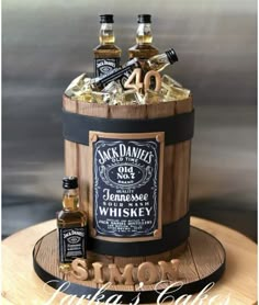 a cake made to look like an old barrel with whiskey bottles on it and the number forty