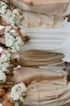 the bridesmaids are all dressed in gold and white gowns with flowers on them