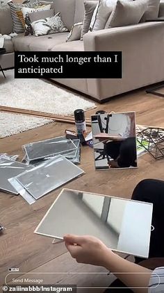 a woman is sitting on the floor with some mirrors in front of her and another person holding a cell phone