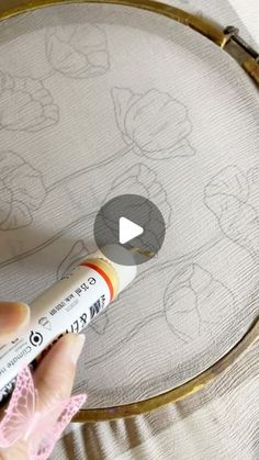 someone is drawing mickey mouses on the fabric with crayons and marker pens