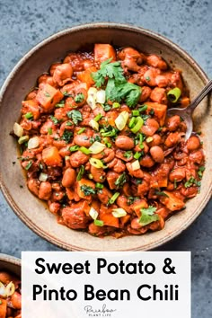 vegan sweet potato pinto bean chili in a bowl with a spoon on the side