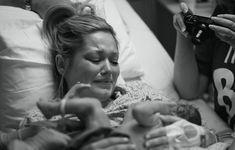 a woman in a hospital bed holding a baby