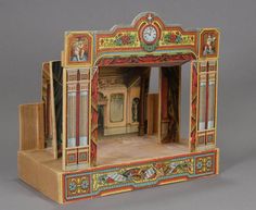 an elaborately painted doll house with a clock