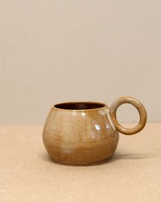 a brown cup sitting on top of a table