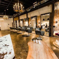 Rustic Salon Furniture Pairings | Minerva Beauty Barndominium Hair Salon, Boho Industrial Salon Decor, Rustic Salon Interior Design, Industrial Beauty Salon, Rustic Hair Salon Ideas, Western Salon Decor, Industrial Salon Design, Rustic Salon Decor, Rustic Salon