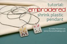 a pair of earrings sitting on top of a piece of fabric with the words, how to make an embroidered shrink plastic pendant