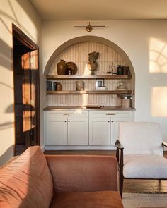 a living room filled with furniture and shelves