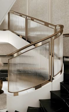 an elegant staircase with black and white marble steps, gold railings and chandelier