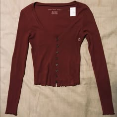 Nwt Deep Red Front Button Top With Lettuce-Cut Sleeve Ends And Bottom, Ribbed/Stretchy Material, V-Neck Style, Fitted Top. Great Color For Fall! Would Look Cute With Jean Jackets, Skirts, Jeans, And Almost Anything Else! Size Xs (American Eagle) Cute Tops For Fall, Deep Red Clothes, Dark Red Clothes, Burgundy Clothing, Cute Long Sleeve Tops, Hp Outfits, Maroon Outfit, Clothing Board, Thrift Haul