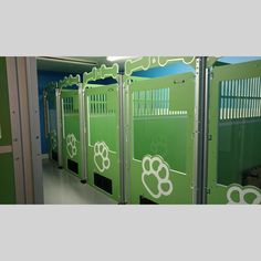 there are many green stalls with white designs on the doors and windows in this room