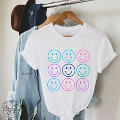 Happy fun graphic tee design in a soft, cozy, lightweight t-shirt. We hope you like it! * 100% combed and ring-spun cotton (Heather colors contain polyester) * Fabric weight: 4.2 oz/yd² (142 g/m²) * Pre-shrunk fabric * Side-seamed construction * Shoulder-to-shoulder taping Refund/Exchange Policy: We do not accept returns or exchanges. Please refer to the sizing chart under the listed product to ensure you're selecting the best fit. Thank you! Cheap Fun White Print T-shirt, Cheap Fun T-shirt With White Print, Oakley Clothes, Smiley Face Shirt, Happy Shirt, Boho Shirt, Shirts Women Fashion, Boho Shirts, Cute Happy