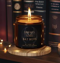 a candle sitting on top of a wooden table next to some books and other items