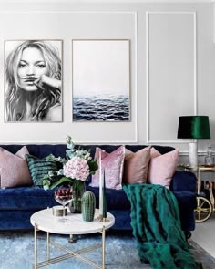 a living room filled with furniture and pictures on the wall above it's coffee table