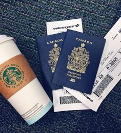 starbucks cup and passport sitting on the ground